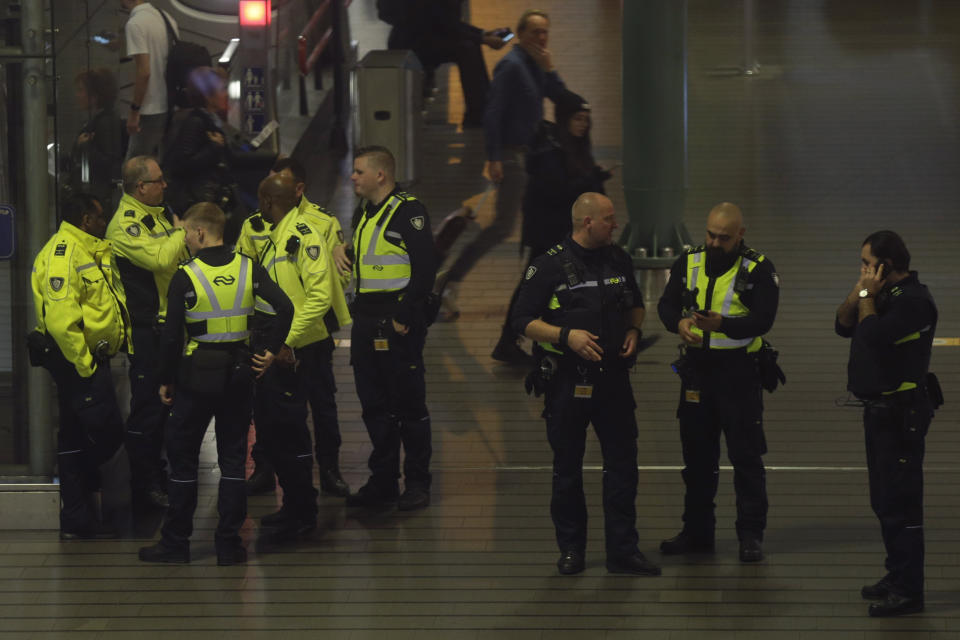 Dutch police mill about after a threat at Schiphol airport in Amsterdam, Netherlands, Wednesday, Nov. 6, 2019. Dutch military police say that all passengers and crew are safely off a plane at the center of a security alert at Amsterdam's Schiphol Airport. The military police service earlier said they were responding to a suspicious situation at the airport on the outskirts of Amsterdam. (AP Photo/Peter Dejong)