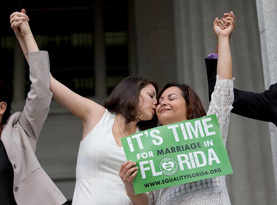 Catherina Pareto, left, and her partner, Karla Arguello, celebrate on the courthouse steps in Miami on Jan. 5, 2015, after winning the right to a Miami-Dade marriage license. Seven years later, some see the U.S. Supreme Court’s overturning Roe v. Wade abortion protections as setting the stage for rolling back federal protections for gay marriage, too.
