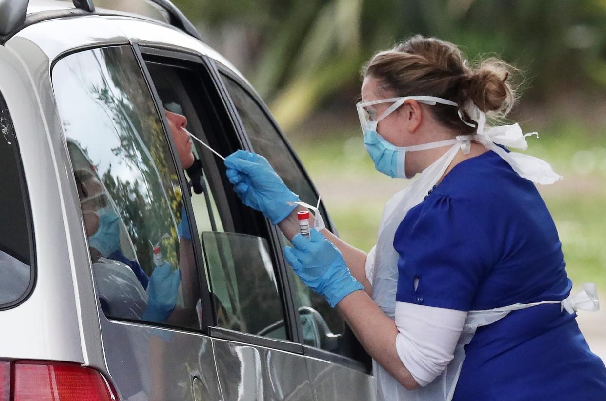 A person is swabbed at a drive-through coronavirus testing site in a car park at Chessington World of Adventures, in southwest London on Thursday: PA