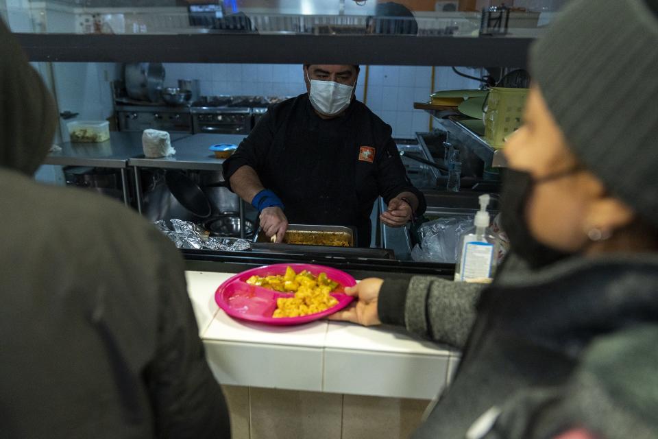 Jose Maria Cervantes offers food to migrants at Kino Border Initiative on Dec. 21, 2022, in Nogales, Sonora, Mexico. Title 42 was scheduled to end on Dec. 21, but was granted a stay by the U.S. Supreme Court.