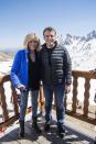 <p>In a black tee, light-wash jeans, ankle boots, and a blue puffer coat with her husband while visiting La Mongie mountain top in the Pyrenees.</p>