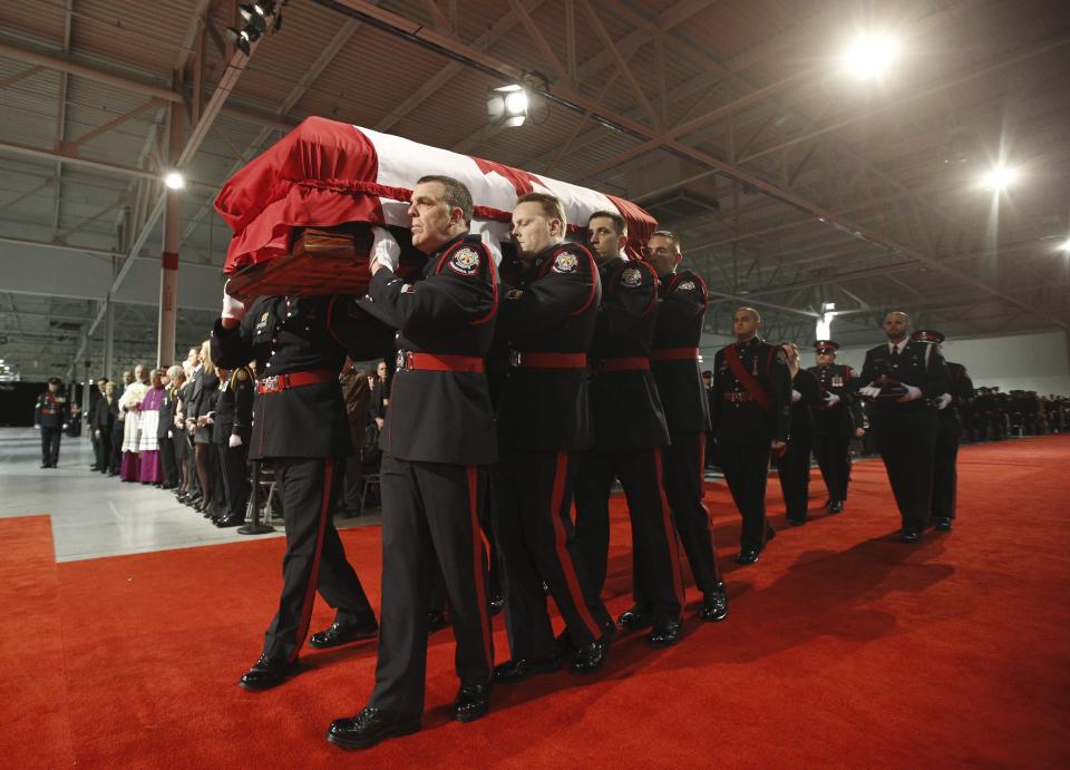 The honor guard carries the casket of police constable John Zivcic into a public memorial in Toronto December 9, 2013. Zivcic died December 2, from injuries he sustained in a car crash while in pursuit of another vehicle. He was Toronto's 26th officer to die while on duty since the Toronto police force began in 1957. REUTERS/Mark Blinch/Pool (CANADA - Tags: OBITUARY CRIME LAW)