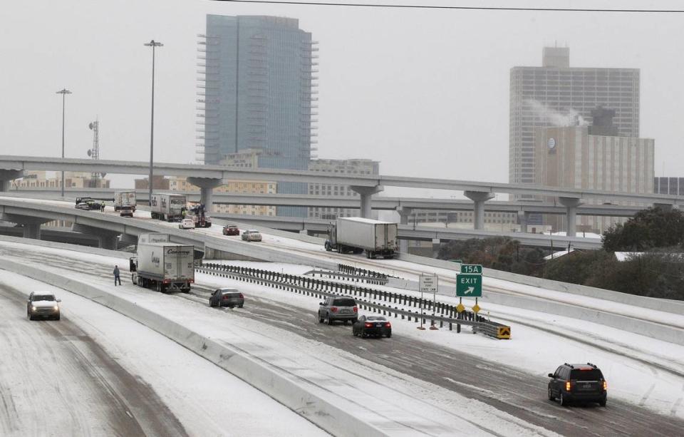 Vehicles try to pass through Fort Worth on Friday, Dec. 6, 2013.