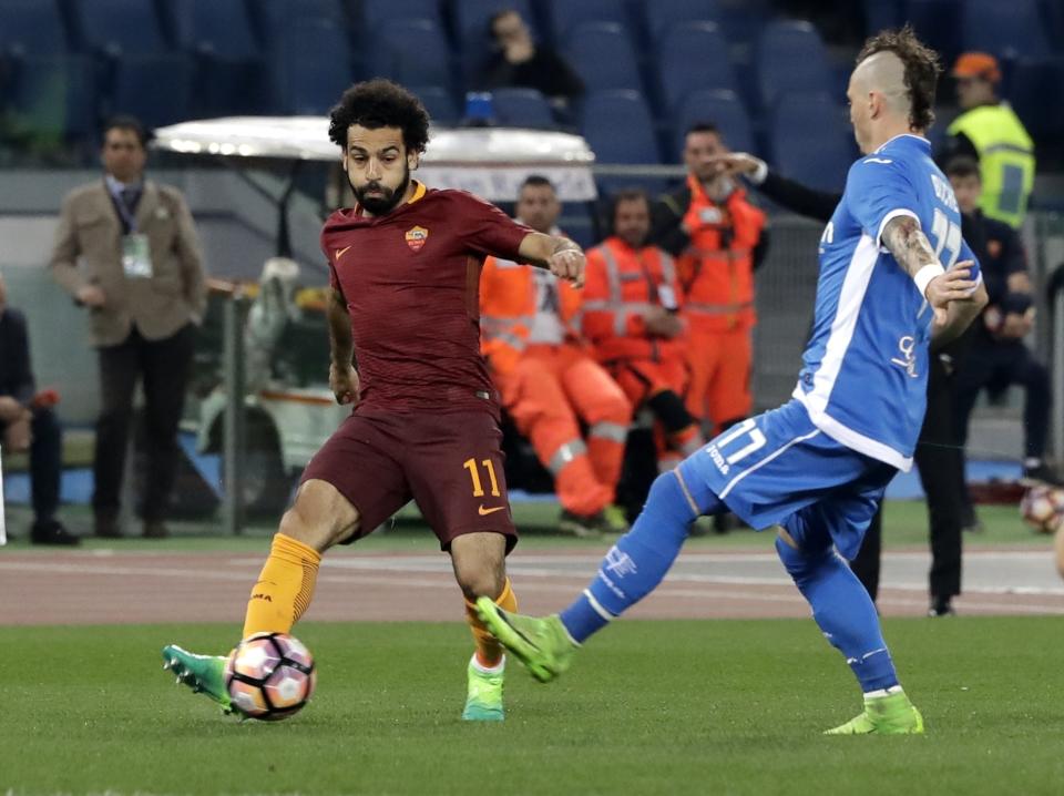 Roma's Mohamed Salah kicks the ball past Empoli's Marcel Buchel during a Serie A soccer match between Roma and Empoli, at the Rome Olympic stadium, Saturday, April 1, 2017. (AP Photo/Alessandra Tarantino)