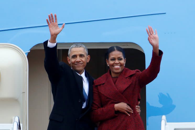 Former President Barack Obama waves with his wife Michelle as they board Special Air Mission 28000, a Boeing 747 which serves as Air Force One, at Joint Base Andrews, Maryland, U.S. Jan. 20, 2017. (Photo: Brendan McDermid/Reuters)