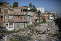 In this Jan. 9, 2014 photo, trash fills an area in the Favela do Metro slum outside Maracana stadium where some homes have been demolished and residents evicted in Rio de Janeiro, Brazil. Some residents in this slum were evicted from their homes two years ago for the area to be renovated for this year's World Cup and 2016 Olympics, but people reoccupied the homes and are fighting to stay. (AP Photo/Felipe Dana)