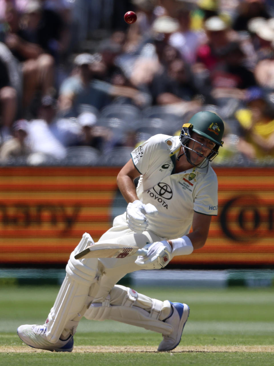 Australia's Pat Cummins is struck by a delivery from Pakistan's Aamer Jamal during the second day of their cricket test match in Melbourne, Wednesday, Dec. 27, 2023. (AP Photo/Asanka Brendon Ratnayake)