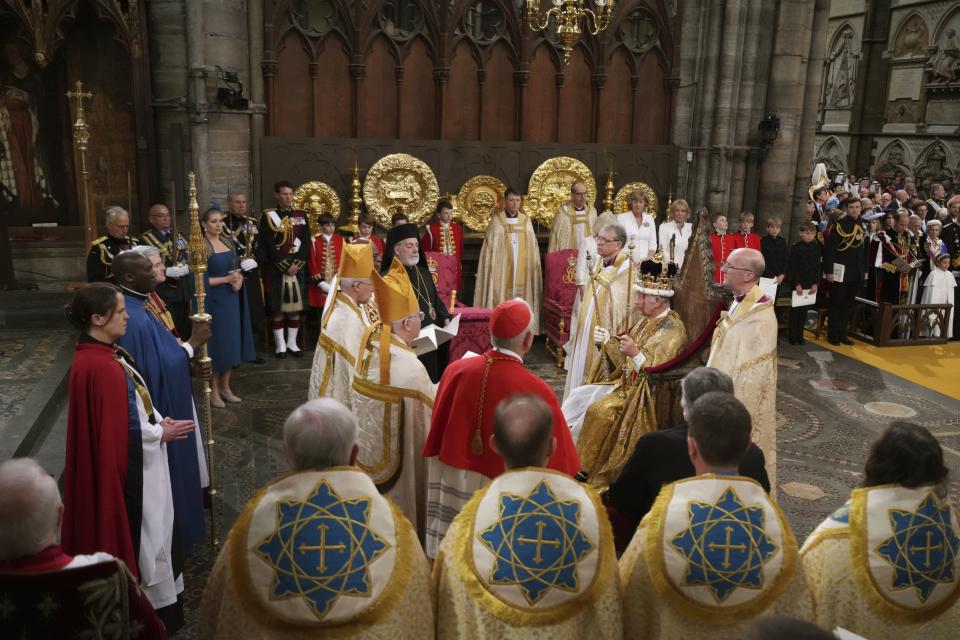 King Charles III crowned with the St Edward’s Crown and surrounded by faith leaders at Westminster Abbey, in London.