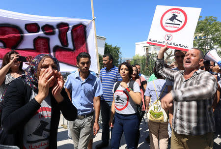 People demonstrate against a bill that would protect from prosecution those accused of corruption, in front of Assembly of the Representatives of the People in Tunis, Tunisia September 13, 2017. The sign reads: "No. We will not forgive". REUTERS/Zoubeir Souissi