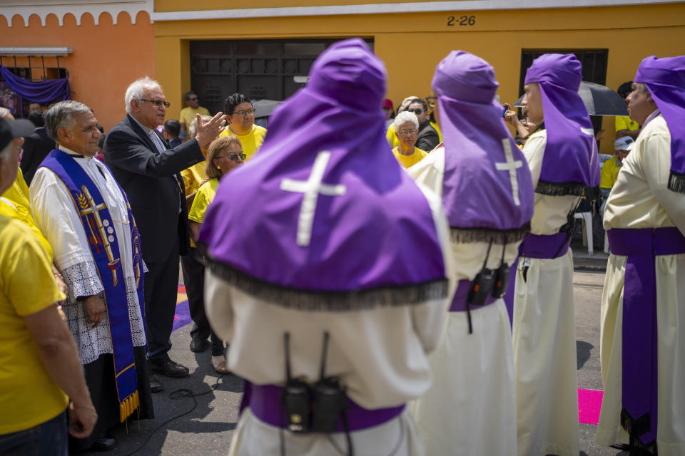 Cardinal Alvaro Ramazzini, with a raised arm, delivers an an impromptu speech to members of the Jesus del Consuelo brotherhood during their annual procession, in Guatemala City, Saturday, March 23, 2024. “Let’s hope that this procession may revive in the heart the willingness to discover Jesus Christ present in the person who suffers,” Ramazzini told them. (AP Photo/Moises Castillo)