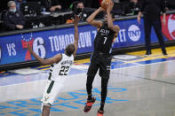 Brooklyn Nets forward Kevin Durant (7) shoots a 3-pointer over Milwaukee Bucks forward Khris Middleton (22) during the fourth quarter of Game 5 of a second-round NBA basketball playoff series Tuesday, June 15, 2021, in New York. The Nets defeated the Bucks 114-108. (AP Photo/Kathy Willens)