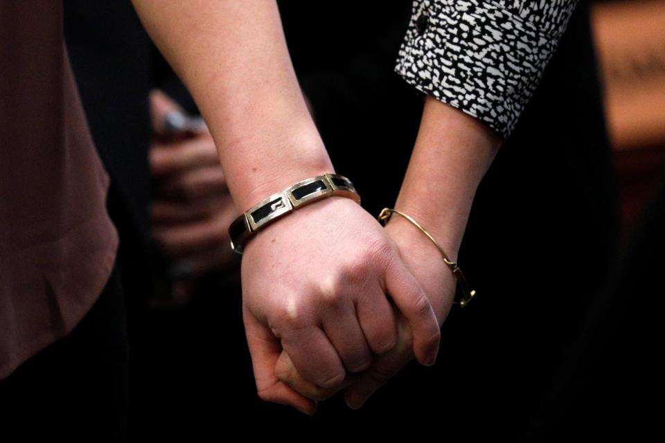 Victims and former gymnasts Maddie and Kara Johnson hold hands as they speak at the sentencing hearing. (Photo: Brendan McDermid/Reuters)