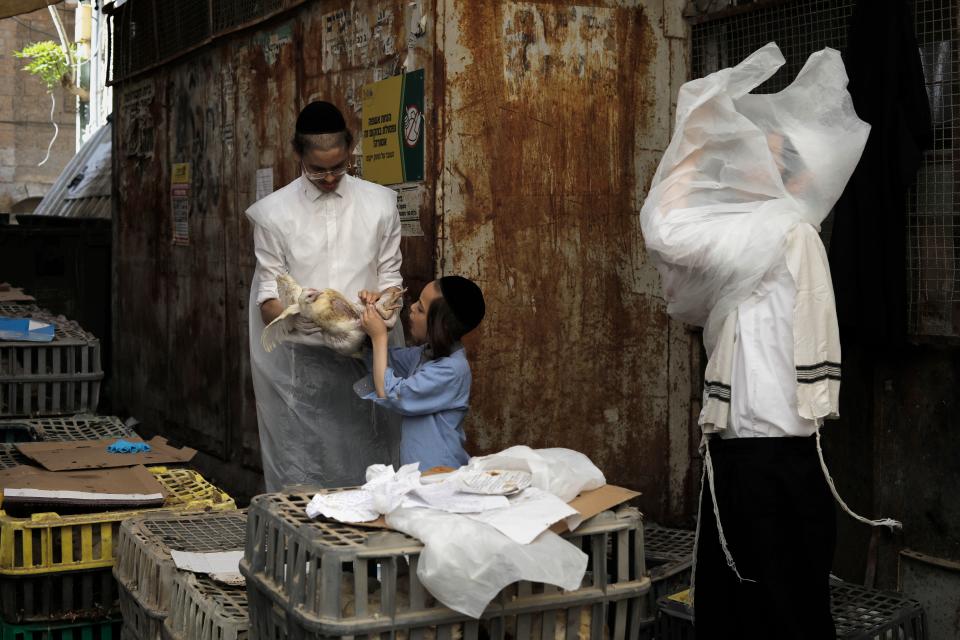 <p>Ultra-Orthodox Jews select a chicken to perform the Kaparot ceremony in the religious neighbourhood of Mea Shearim in Jerusalem on Sept. 27, 2017. The Jewish ritual is supposed to transfer the sins of the past year to the chicken, and is performed before the Day of Atonement, or Yom Kippur, the most important day in the Jewish calendar, which will start this year on September 29 at sunset. (Photo: Menahem Kahana/AFP/Getty Images) </p>