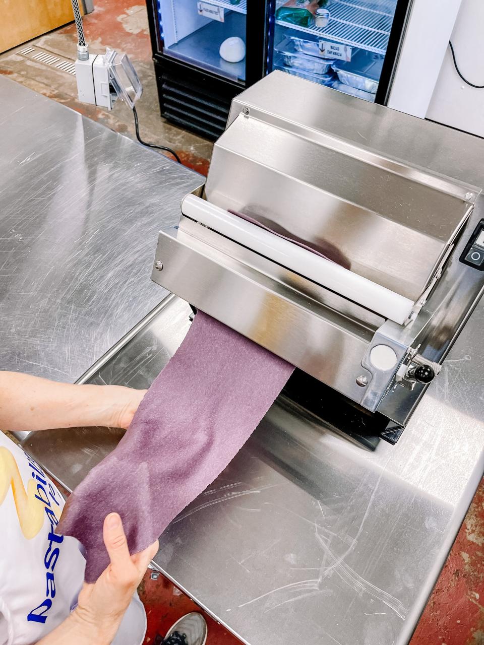 A special order of Pastabilities’ spring colored pasta dough is sheeted before it is filled.