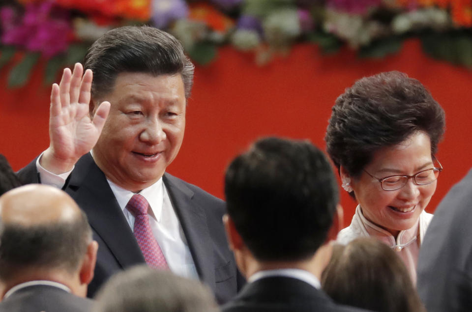 FILE - Chinese President Xi Jinping, left, and Hong Kong's new Chief Executive Carrie Lam attend the ceremony of administering the oath for a five-year term in office at the Hong Kong Convention and Exhibition Center in Hong Kong on July 1, 2017. Hong Kong’s police force on Tuesday, June 28, 2022, confirmed that Chinese president Xi Jinping will visit the city for the 25th anniversary of the former British colony’s return to Chinese rule. (AP Photo/Kin Cheung, File)