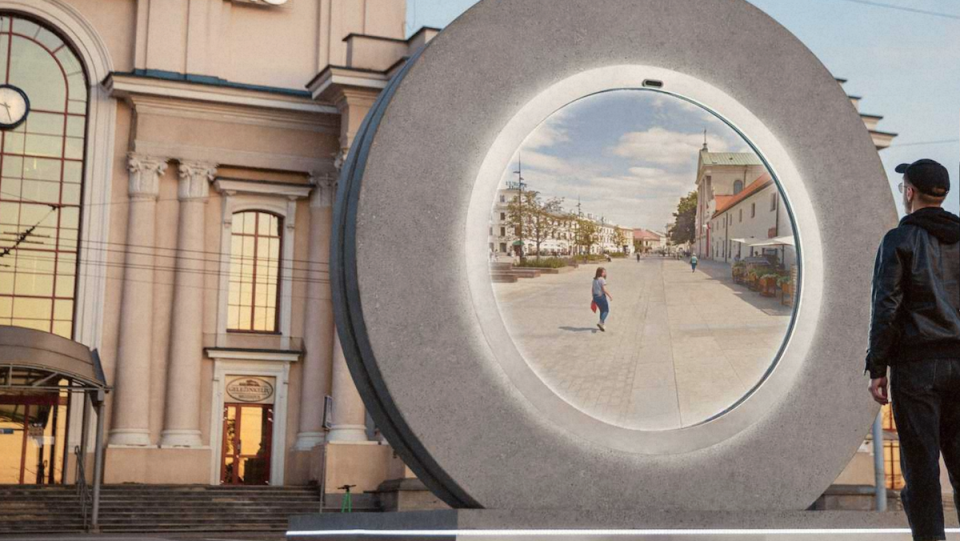 A man stares into a portal showing live video of another city.