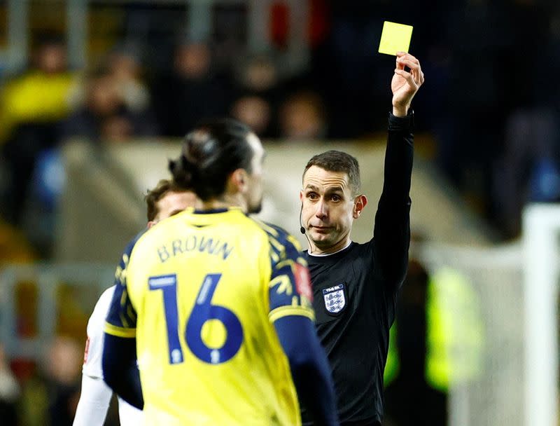 FILE PHOTO: Oxford United's Ciaron Brown is shown a yellow card