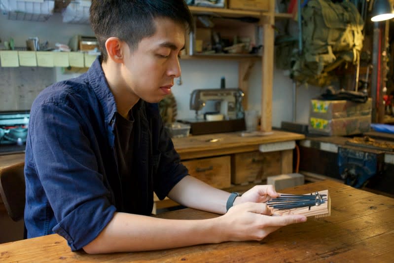 Kevin Cheung, an upcycling product designer, holds a "Glory to Hong Kong" thumb piano that he made using the ribs of umbrellas left over from protests this summer, in Hong Kong