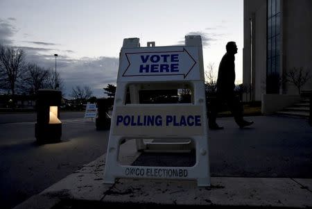 An early morning voter walks into St. Lukes United Methodist Church to cast their vote in Oklahoma City, Oklahoma March 1, 2016. REUTERS/Nick Oxford/File Photo