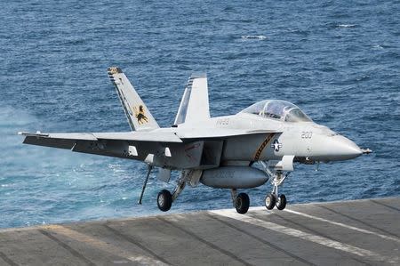 A F/A-18F Super Hornet attached to the Fighting Black Lions of Strike Fighter Squadron (VFA) 213 lands aboard the aircraft carrier USS George H.W. Bush (CVN 77) after conducting strike missions against the Islamic State of Iraq and the Levant (ISIL), also known as the Islamic State, targets, in the Gulf, September 23, 2014, in this handout picture courtesy of the U.S. Navy. REUTERS/Mass Communication Specialist 3rd Class Brian Stephens/U.S. Navy/Handout via Reuters