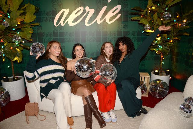 <p>Michael Simon</p> Amber Mark poses with Avani Gregg, Aly Raisman and Iris Apatow at Aerie's Holiday Cozy and Comfy Lounge in New York City.