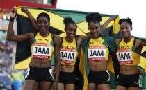 Athletics - Gold Coast 2018 Commonwealth Games - Women's 4x400m - Final - Carrara Stadium - Gold Coast, Australia - April 14, 2018. Christine Day, Anastasia Le-Roy, Janieve Russell and Stephenie McPherson of Jamaica pose after winning the gold medal. REUTERS/Paul Childs