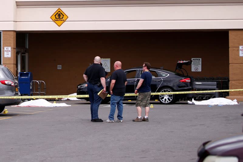 Police officers secure the scene after a shooting at TOPS supermarket in Buffalo