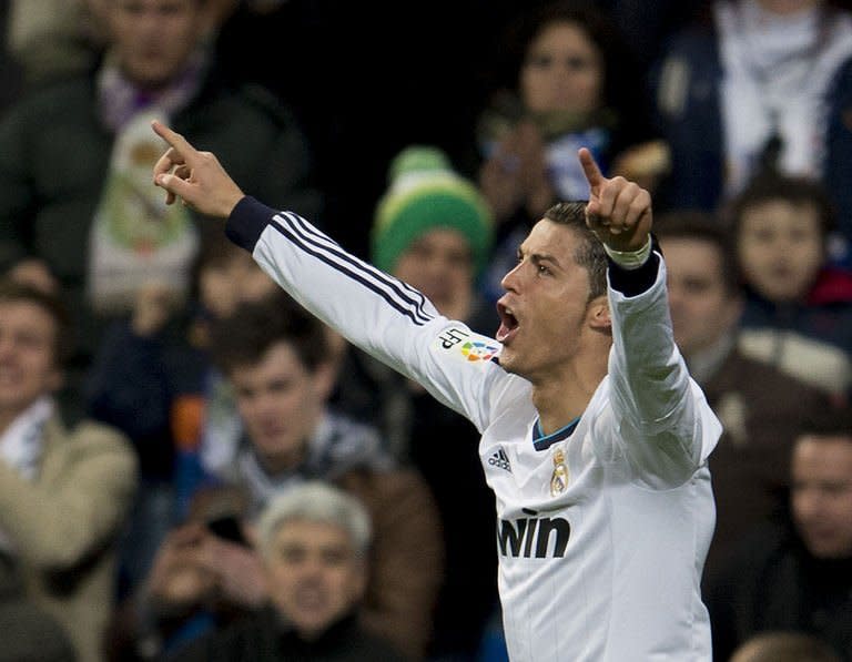 Real Madrid's Cristiano Ronaldo celebrates scoring against Sevilla at the Santiago Bernabeu on February 9, 2013. Ronaldo scored his 20th hat-trick as a Real Madrid player as the Spanish champions cruised to a 4-1 victory