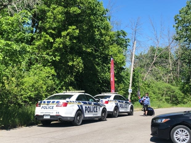 Gatineau Police Service patrol cars are parked near the scene of a skydiving accident near the city's airport on May 29, 2021. Two men died in the accident, police told Radio-Canada. (Marielle Guimond/Radio-Canada - image credit)