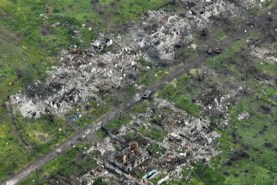 An aerial view of damaged private houses, shell and rocket craters in the suburbs of Donetsk, the site of fierce battles with the Russian forces, Ukraine, Friday, May 26, 2023. (AP Photo/Efrem Lukatsky)