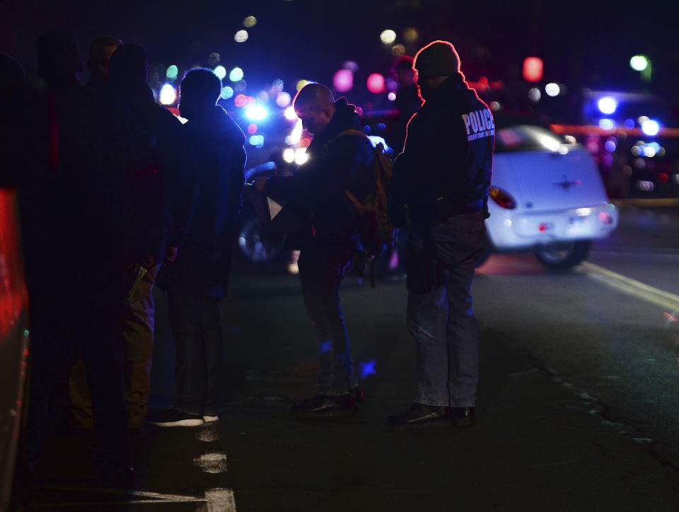 Detroit Police officers gather on the corner of Wyoming and Chippewa streets where one officer was fatally shot and another was wounded while responding to a home invasion on Detroit’s West Side, late Wednesday, Nov. 20, 2019. (Clarence Tabb Jr./Detroit News via AP)