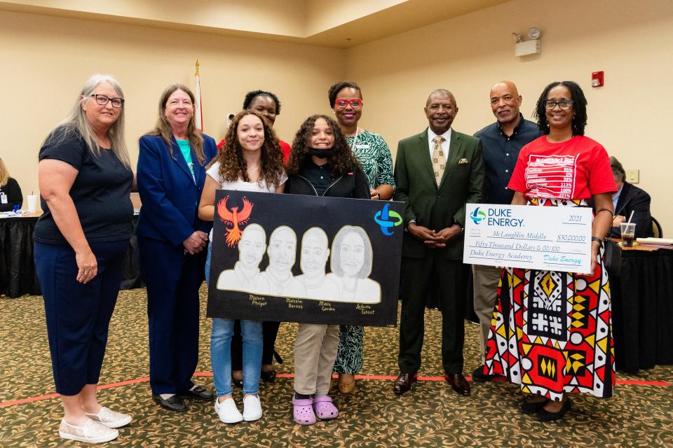 McLaughin Middle School staff and students received a check from Duke Energy representatives for $50,000 recently as part of a community partnership.  Art students created an original work to thank the company.