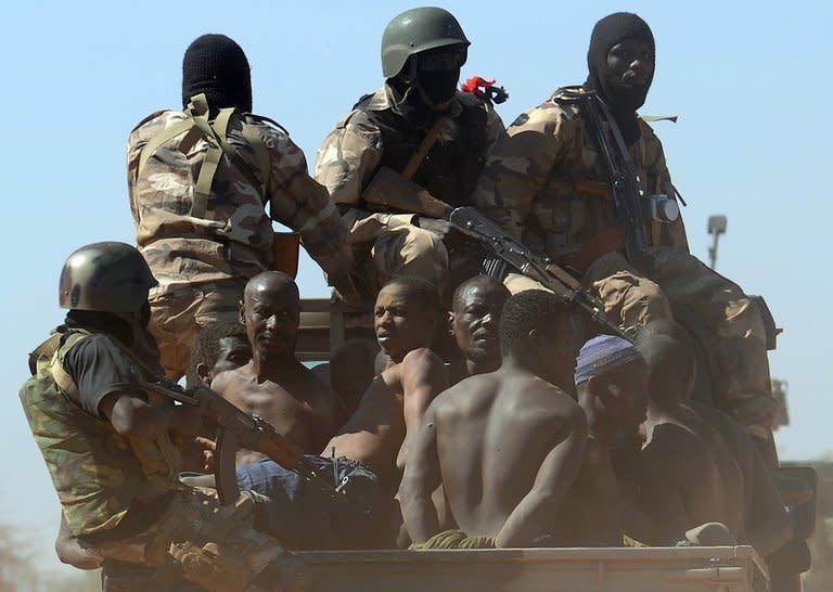 Malian soldiers transport suspected Islamist rebels after arresting them north of Gao, on February 8, 2013. A suicide bomber blew himself up in northern Mali as a dramatic turn towards guerrilla tactics by Islamists and an outbreak of fighting among soldiers in the capital show the war is far from won for the embattled nation