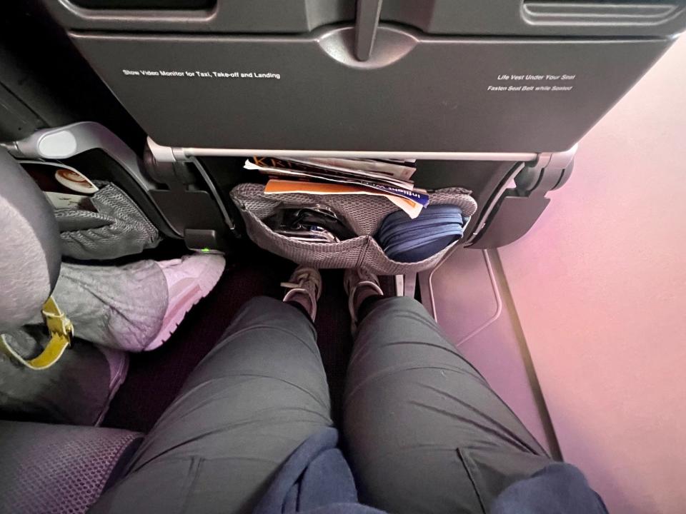 My legs in the seat viewed from above.