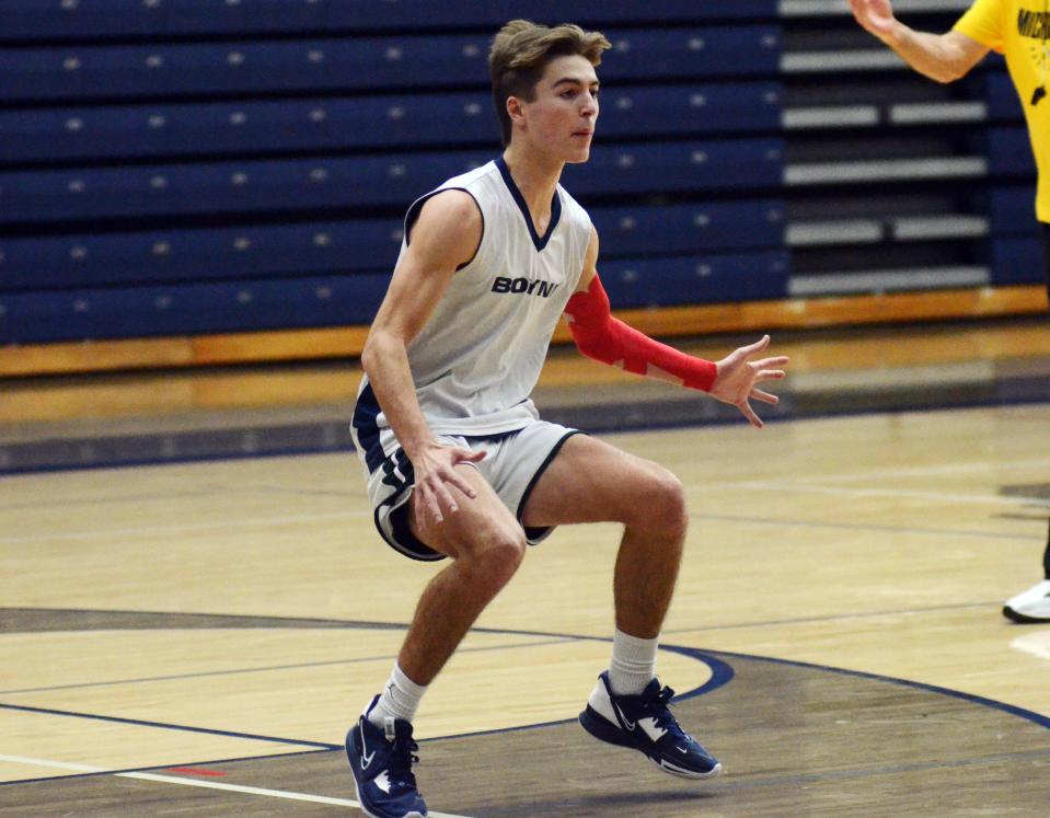 Boyne City senior guard Mason Wilcox breaks down to guard someone during practice this week in the Boyne City High School gym.