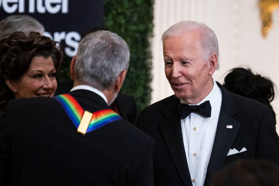 President Joe Biden greets George Clooney during a reception for Kennedy Center honorees at the White House in December, 2022. 