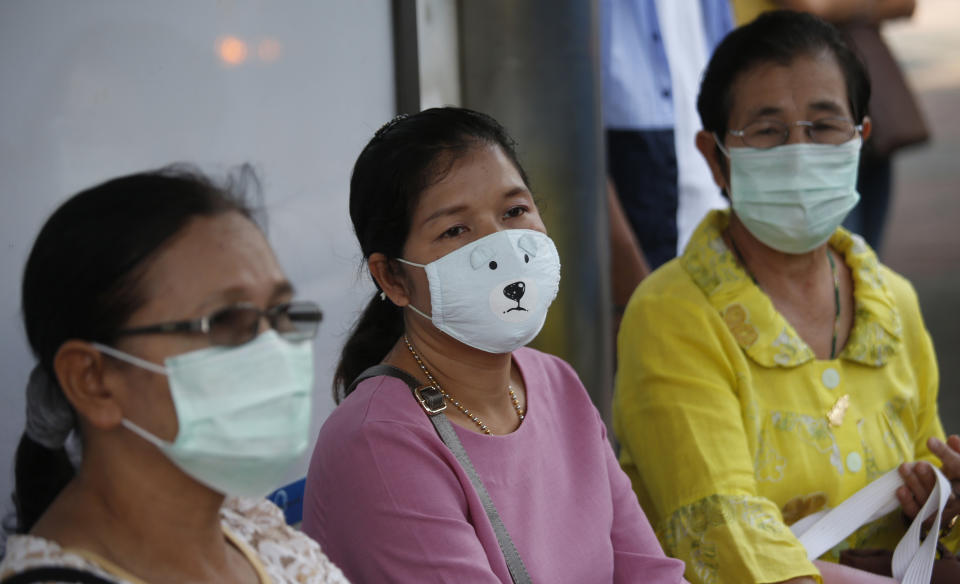 Women protective mask at the bus stop in heavy air pollution in Bangkok, Thailand, Monday, Jan. 14, 2019. Unusually high levels of smog worsened by weather patterns are raising alarm across Asia. (AP Photo/Sakchai Lalit)