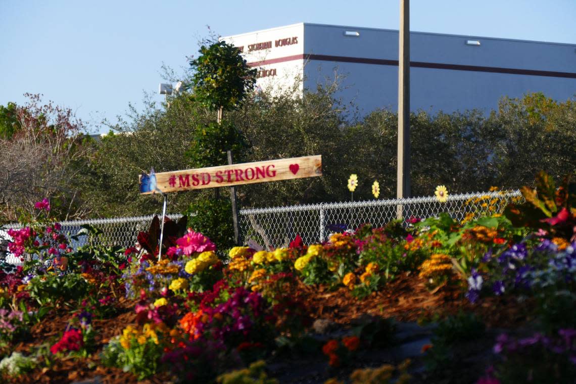 Flowers and colorful stones and messages adorn a memorial at the corner of the Marjory Stoneman Douglas High school campus on the first anniversary of the shooting massacre, Thursday, Feb. 14, 2019.