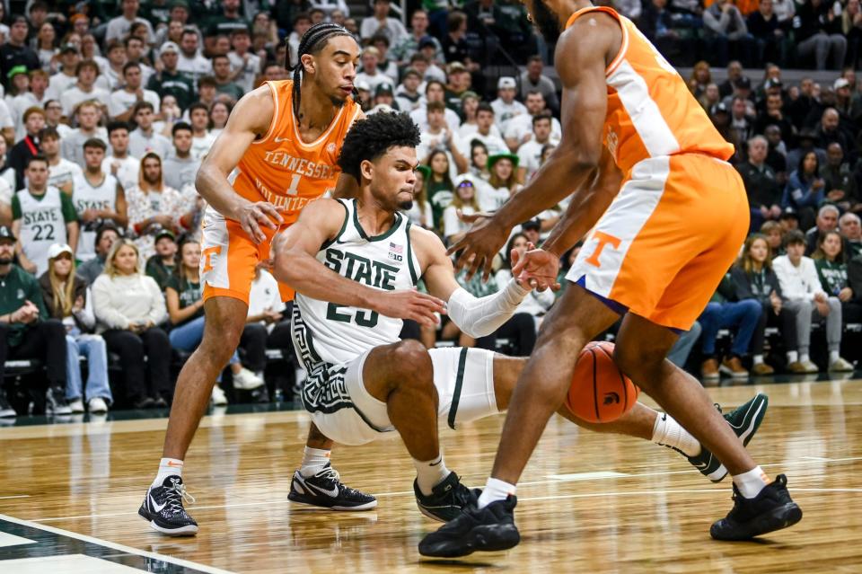 Michigan State's Malik Hall, center, battles for the ball with Tennessee's Freddie Dilione V, left, and Josiah-Jordan James during the first half on Sunday, Oct. 29, 2023, at the Breslin Center in East Lansing.