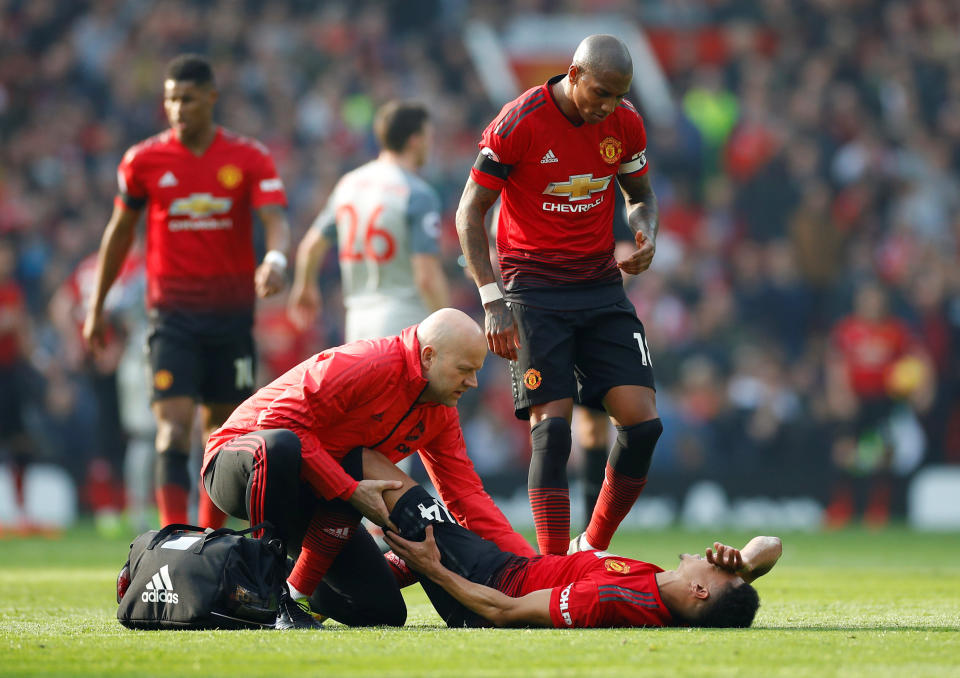 Manchester United’s Jesse Lingard receives treatment from the physio after suffering an injury during the English Premier League clash with Liverpool. (PHOTO: Reuters/Phil Noble)