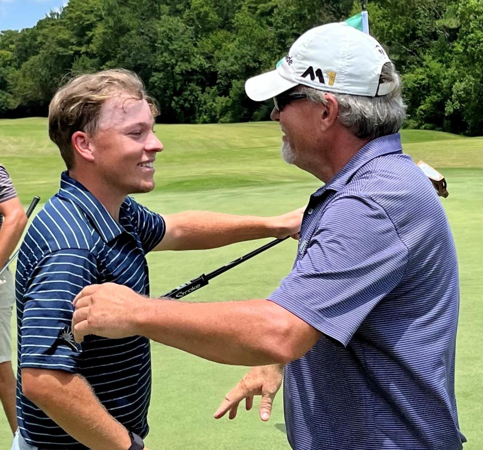 Jason Duff (left) is congratulated by his father Terry after he completed a final-round 64 to win the Jacksonville Amateur by 11 shots at the Deerwood Country Club on Saturday.