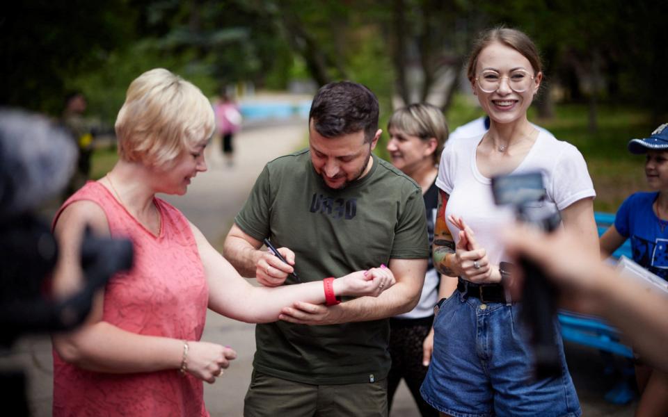 The president even signed a local woman's arm during his visit to the region - Reuters