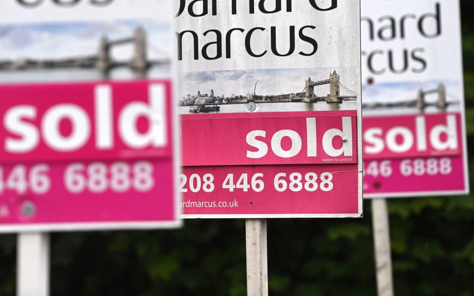 Estate agent boards are spiked on properties in London, Britain