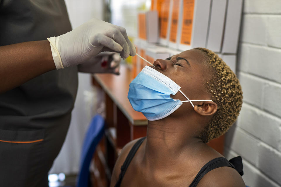 Volunteer Thabisle Khlatshwayo, who received her first shot for a COVID-19 vaccine trial, is tested before receiving her second shot at a vaccine trial facility set at Soweto's Chris Sani Baragwanath Hospital outside Johannesburg, South Africa, Monday Nov. 30, 2020. Over 2000 South African volunteers are on AstraZeneca's experimental coronavirus vaccine trial. (AP Photo/Jerome Delay)