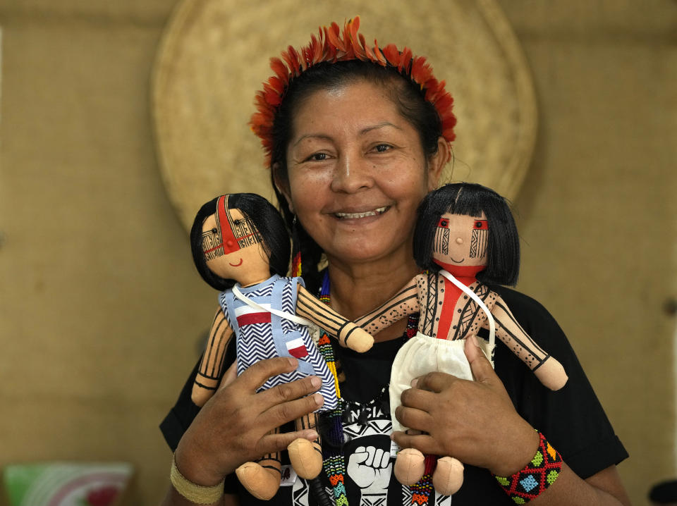 Luakam Anambe, of Brazil’s Anambé indigenous group, who is at the helm of a small, burgeoning business selling handmade indigenous dolls poses for a photo in her sewing workshop at her home in Rio de Janeiro, Brazil, Tuesday, May 24, 2022. Part of the money she makes from her dolls goes toward a social project Luakam has been putting together in Para state, to help women in need. (AP Photo/Silvia Izquierdo)