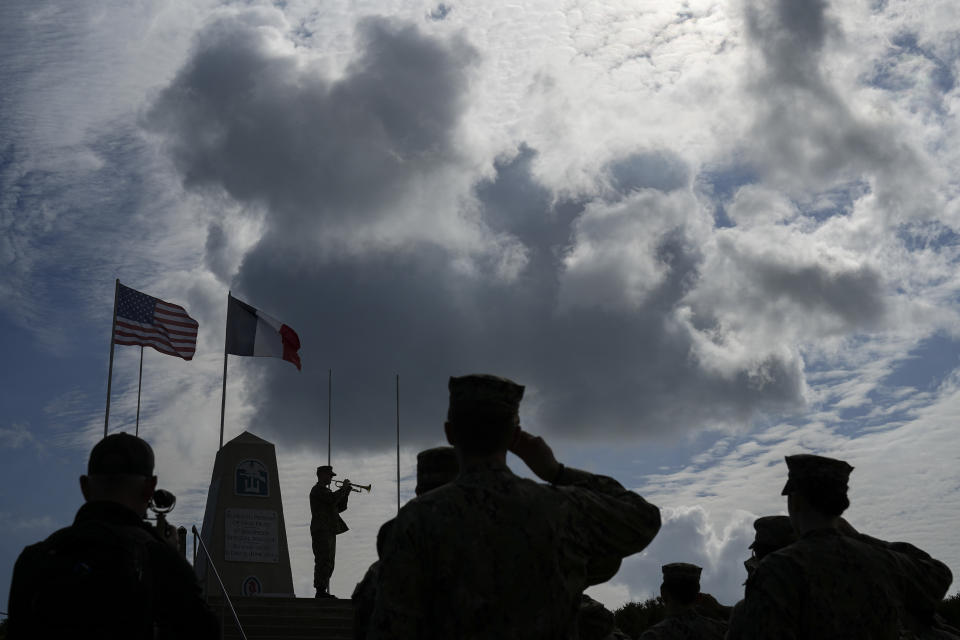 Members of the U.S. joint military service academy choir take part in a ceremony at Utah Beach near Sainte-Marie-du-Mont, Normandy, France, Wednesday, June 5, 2024. (AP Photo/Daniel Cole)