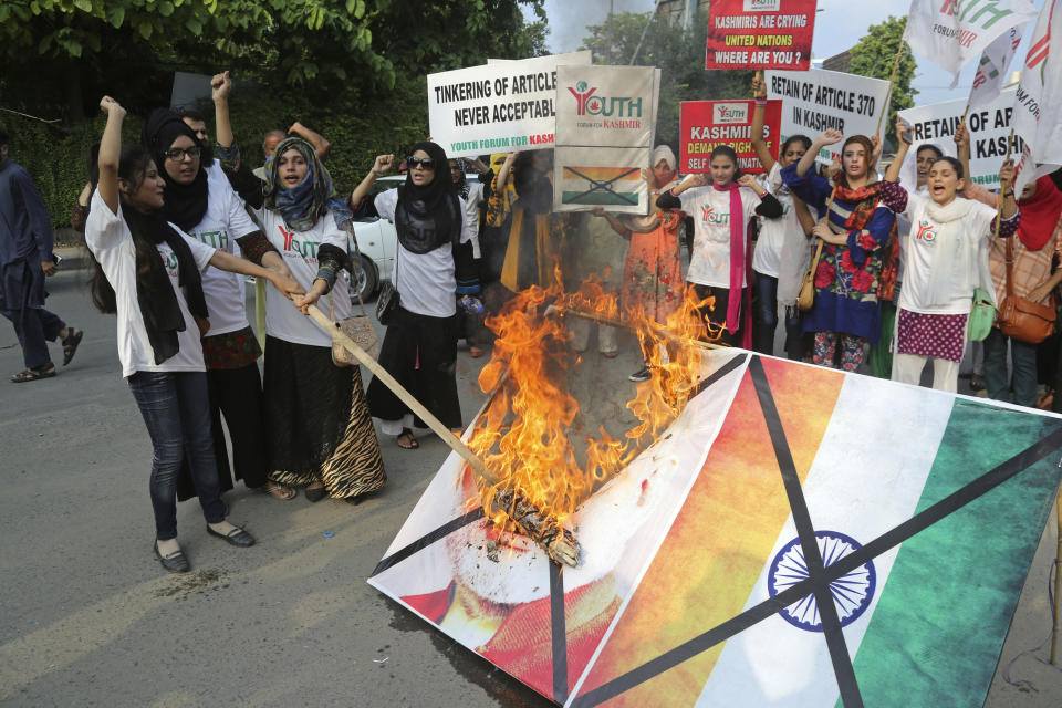 Pakistani students burn a poster of Indian Premier Narendra Modi during an anti-Indian rally in Lahore, Pakistan, Wednesday, Aug. 7, 2019. Pakistan has decided to downgrade its diplomatic ties with neighboring India and suspend bilateral trade in response to New Delhi's decision to reduce the special status of Kashmir, a Himalayan region claimed by both countries. (AP Photo/K.M. Chaudary)