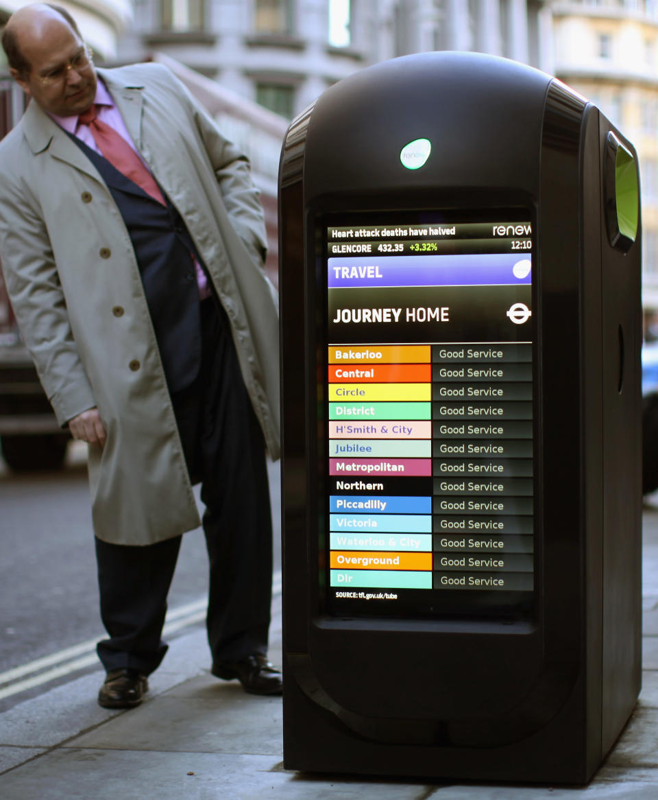 A man looks at a newly-installed 'Renew' media point in the City of London. The pods will transmit breaking news and information about weather, travel, sport, fashion, arts and entertainment. The stations will also double as recycling points.