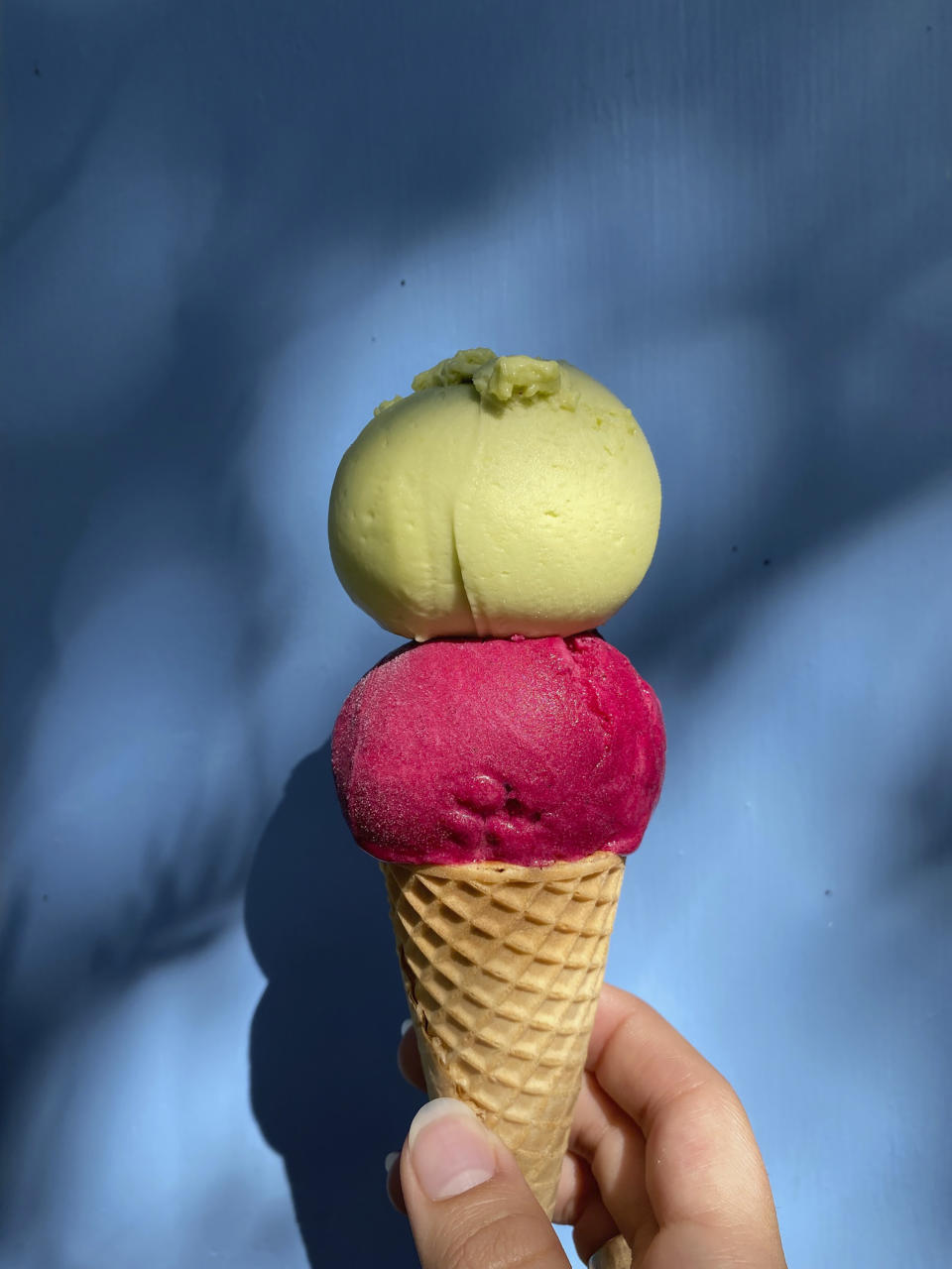 This image provided by Fortune's Ice Cream shows a cone topped with pineapple avocado and raspberry rose sorbets. Unique flavors are among the biggest trends in the frozen treat business; many smaller shops and operations are coming up with imaginative solo and combination flavors. (Fortune's Ice Cream via AP)