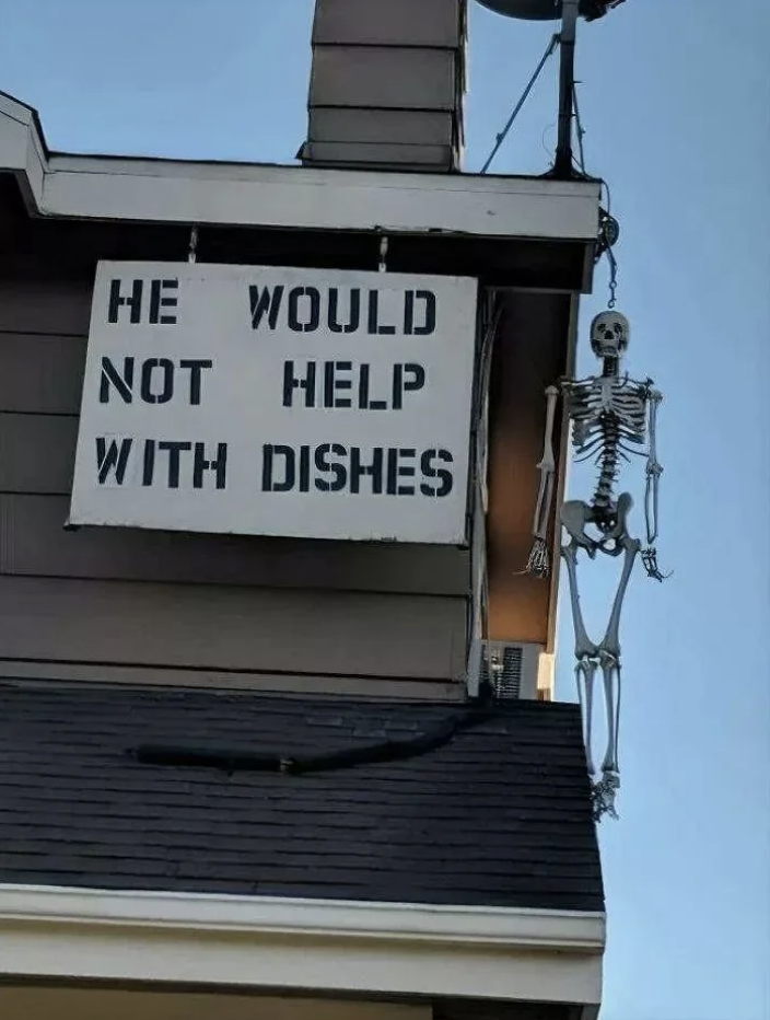 House with a skeleton decoration hanging and a sign that reads 